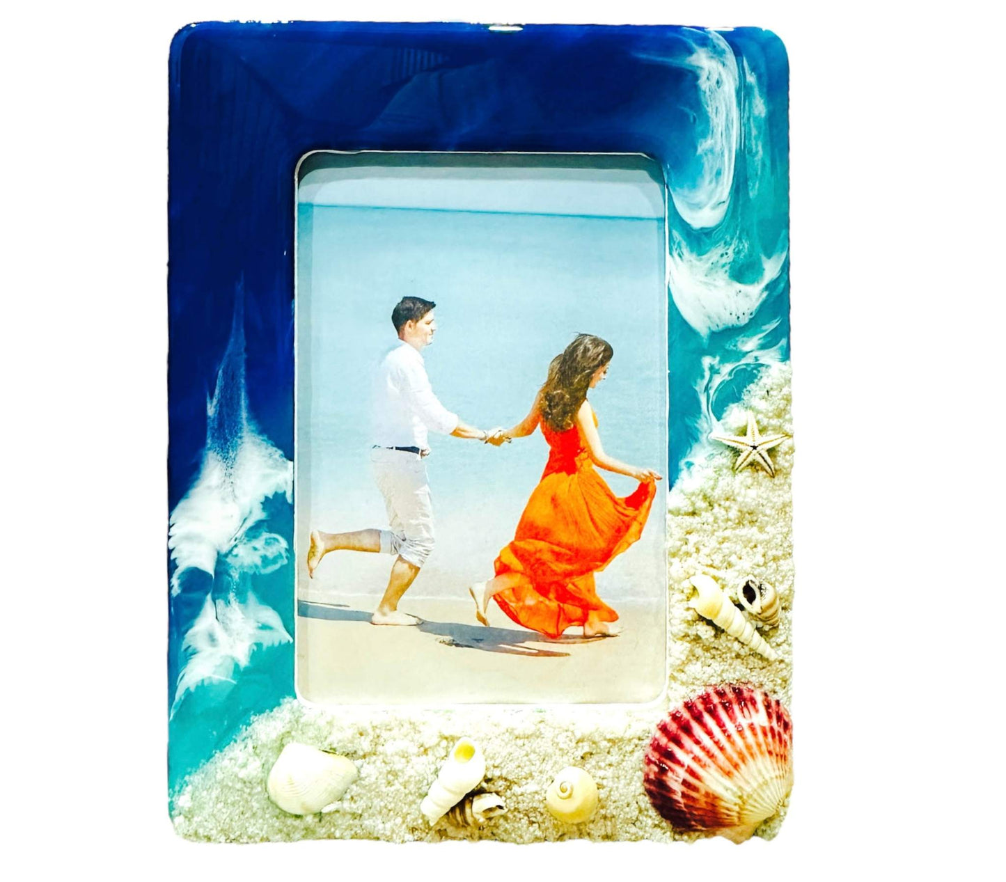 Ocean wave photo frame with blue and white resin waves decorated with seashells and starfish.