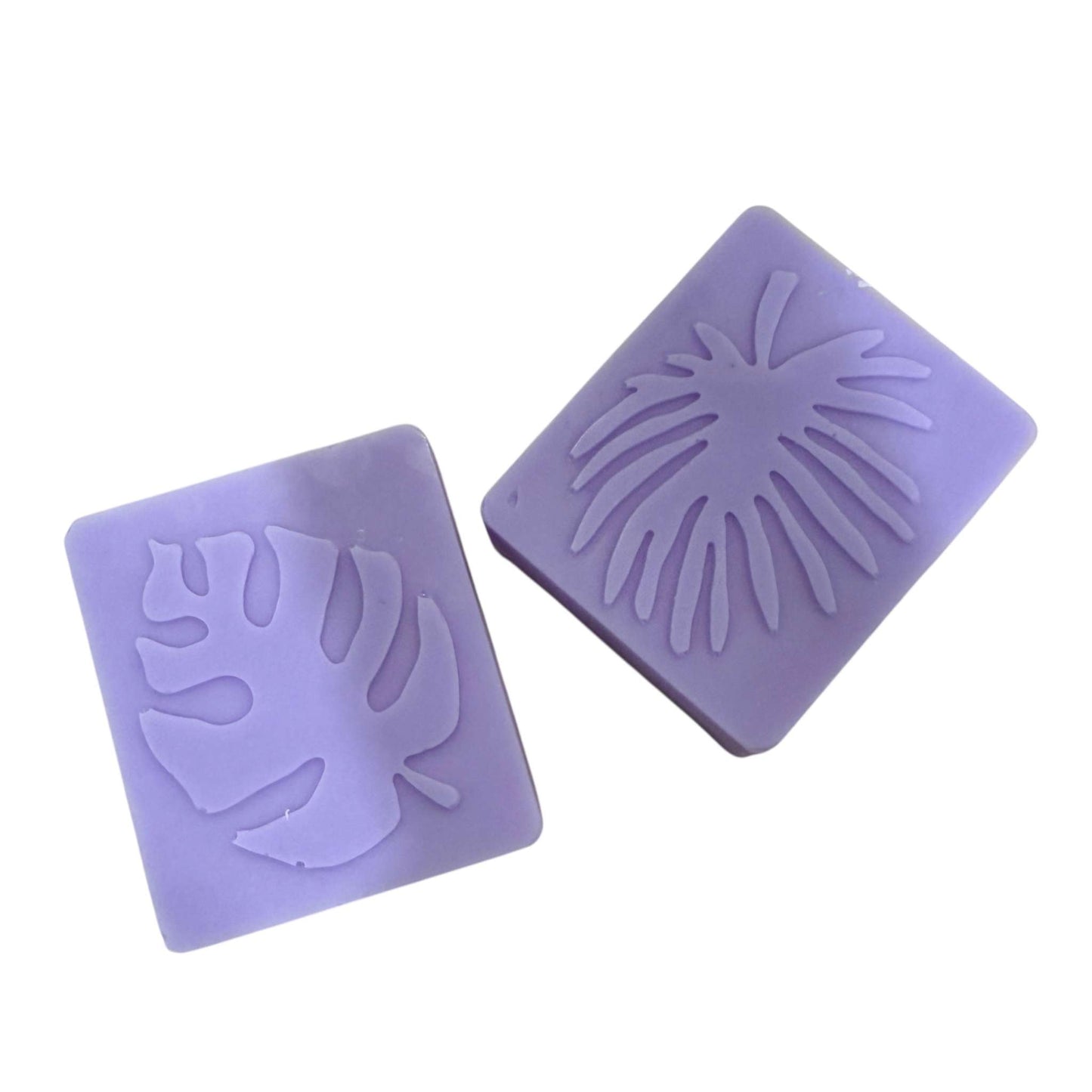 Two purple organic shea soap bars with embossed leaf designs, part of a customizable gift basket for mom.