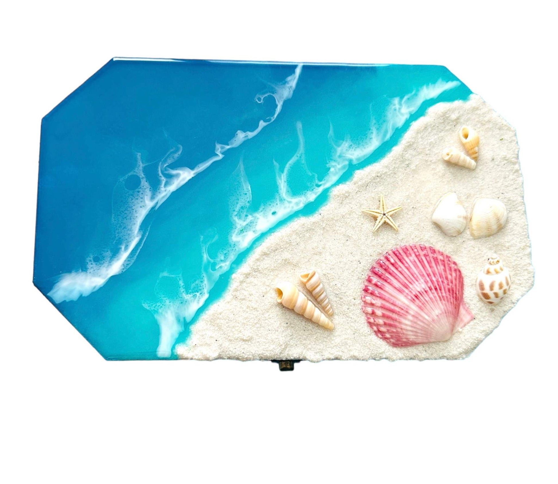 Organizer box with ocean wave design and seashell decorations on sandy surface