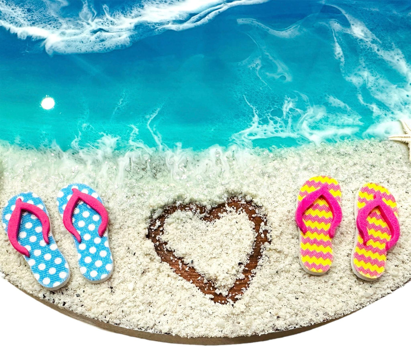Beach view wall hanging with resin waves, sandy shore, heart shape in sand, and colorful miniature slippers