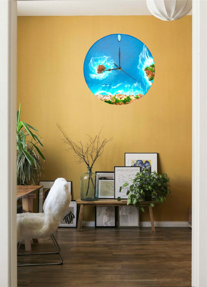 Round resin ocean wall clock with island, ocean waves, beach, rocks, and miniature boat decor in blue and sandy tones hanging on yellow wall in modern living room.
