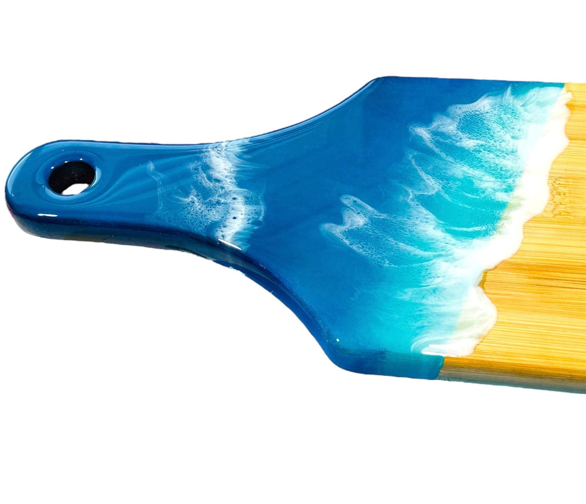 Ocean wave resin cheese board with handcrafted blue and white ocean wave design on bamboo wood base, coastal cheese serving board with handle.