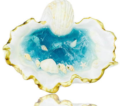 Sea Shell shaped jewelry plate with blue resin interior and small decorative seashells.