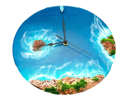 Round resin ocean wall clock with blue waves, island, rocks, and greenery design