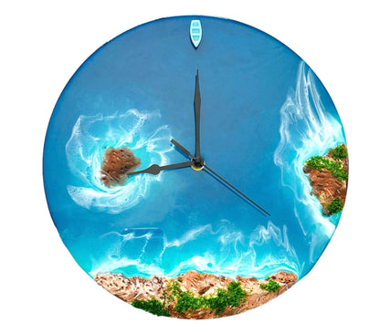 Round resin ocean wall clock featuring island, ocean waves, beach, rocks, and a miniature boat with turquoise resin waves.