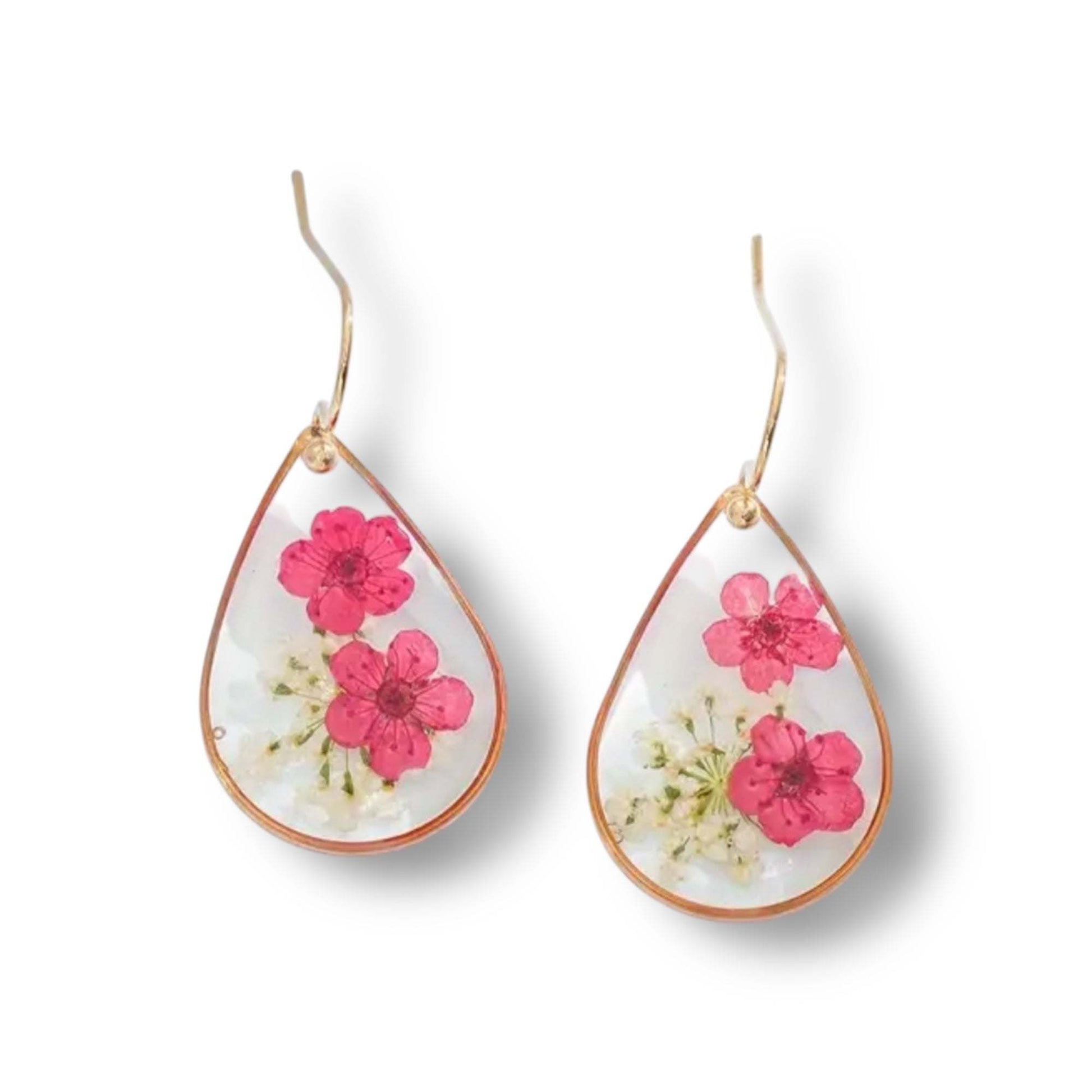 Handcrafted drop-shaped earrings with real dried pink and white flowers encased in clear resin and gold-plated hooks