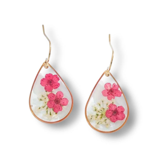 Handcrafted drop-shaped earrings with real dried pink and white flowers encased in clear resin and gold-plated hooks