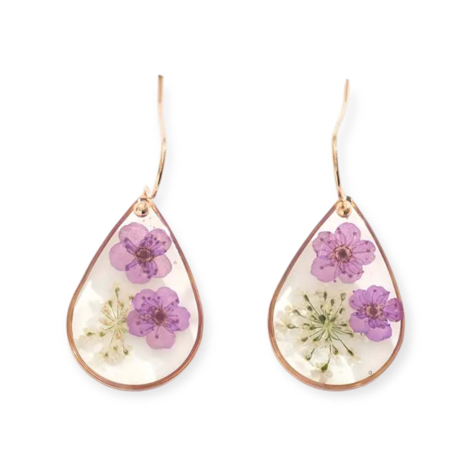 Handcrafted drop-shaped earrings with real dried purple and white flowers encased in clear resin and 14K gold plated hooks