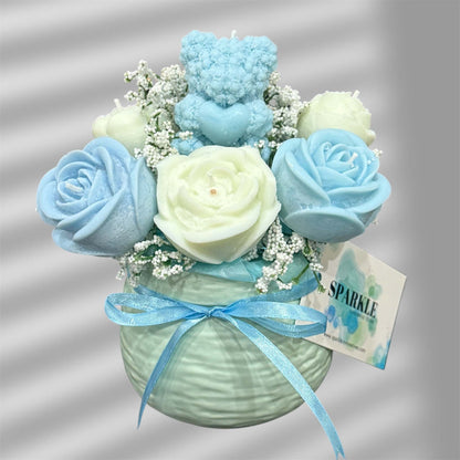Handmade candle flower bouquet in blue and cream with teddy bear candle in a decorative vase