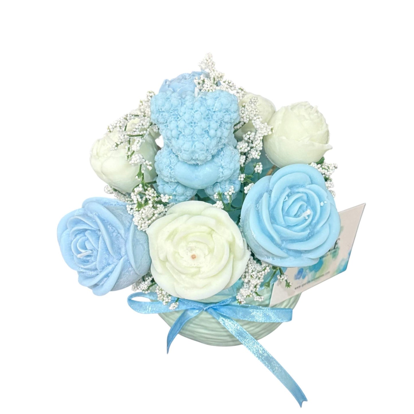 Handmade scented candle flower bouquet in blue and cream with a teddy bear candle in a decorative vase