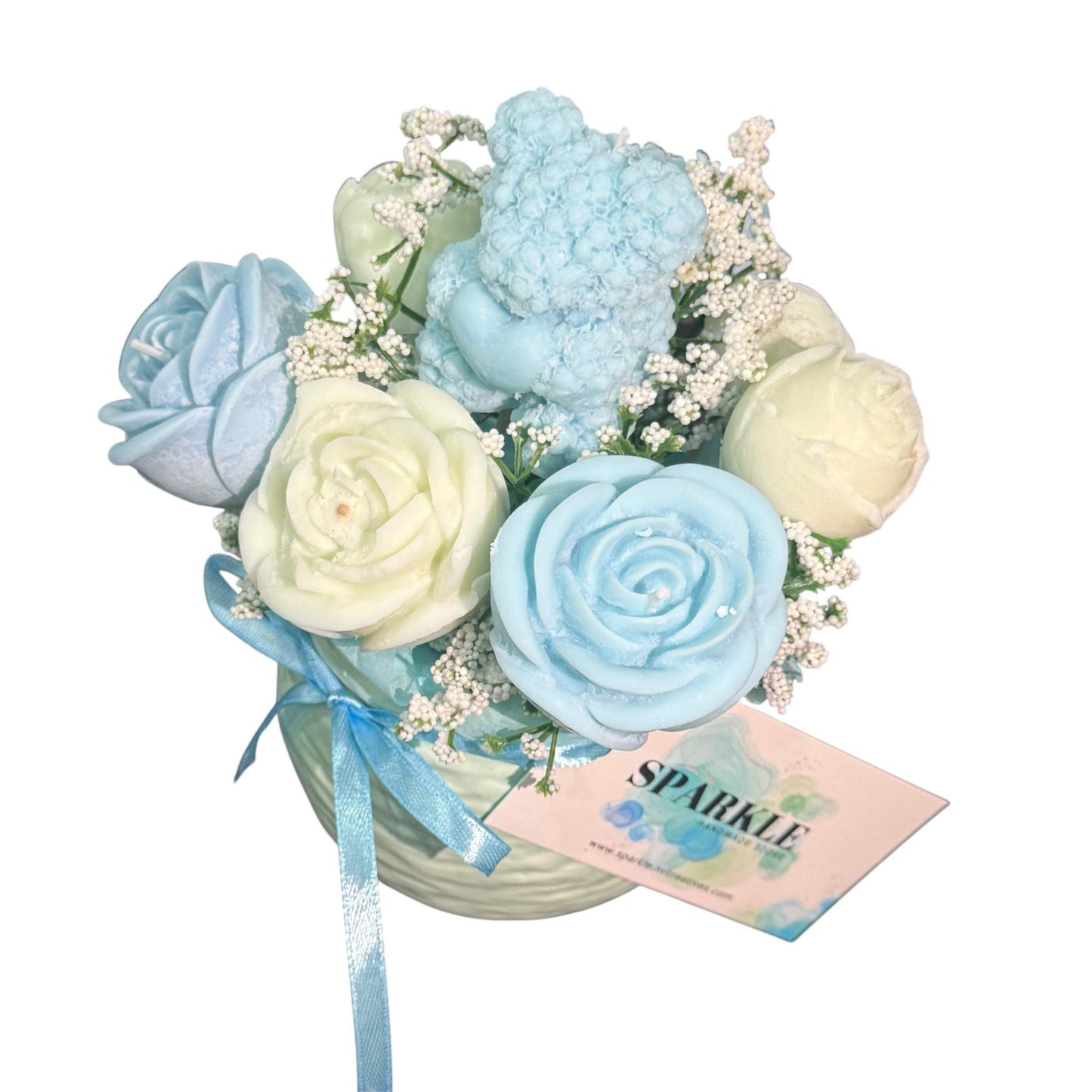 Handmade candle flower bouquet in blue and cream hues with a blue teddy bear candle in a decorative vase
