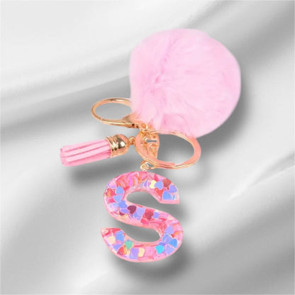 Pink fluffy alphabet keychain with decorative letter S and tassel charm