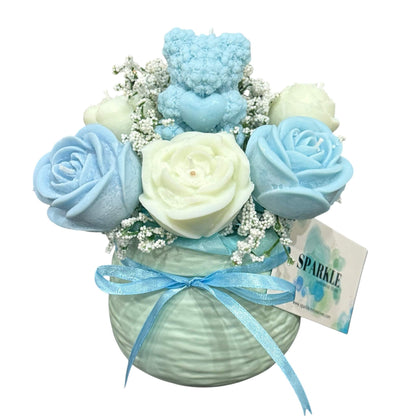 Customizable gift basket for mom with blue and white floral bouquet and decorative teddy bear candle in light green vase with blue ribbon