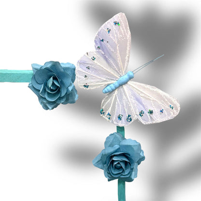 Decorative white butterfly and blue paper flowers on stick for customizable gift basket embellishment