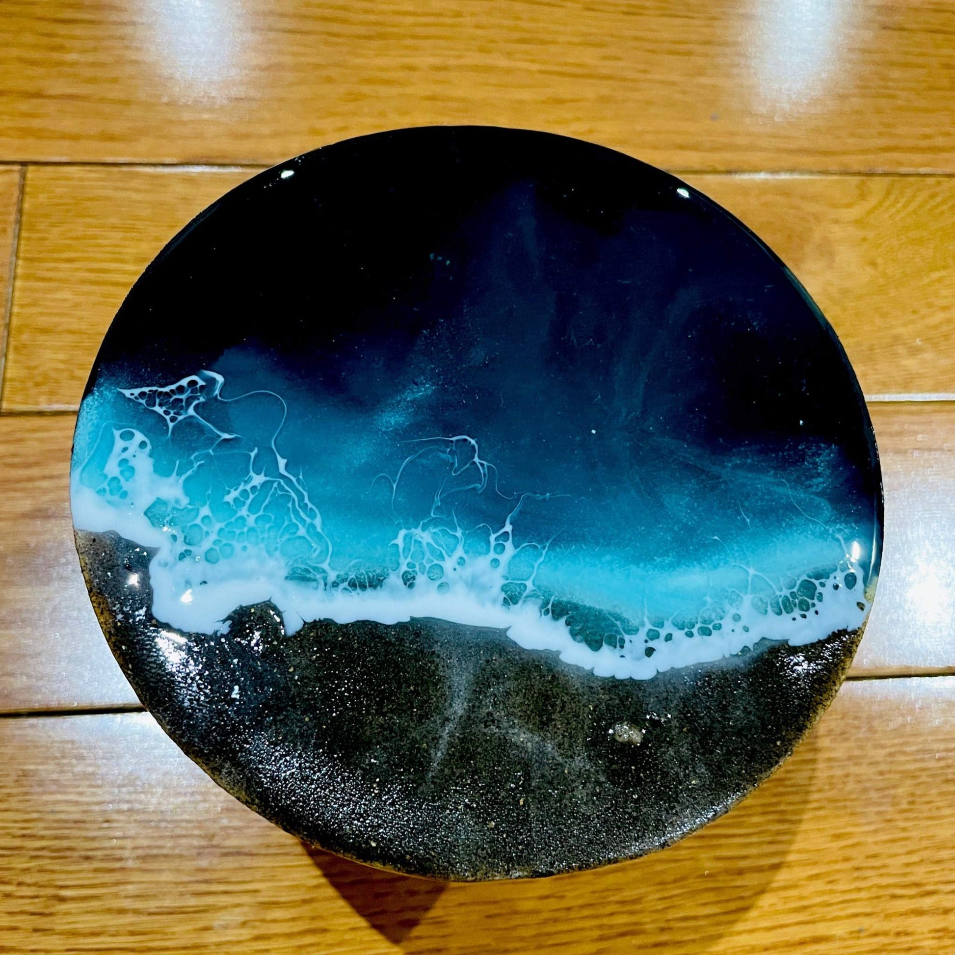 Handmade ocean art with black sand on 4-inch wooden board featuring 3D beach wave layers and resin finish