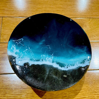 Handmade ocean art with black sand on 4-inch wooden board featuring 3D beach wave layers and resin finish