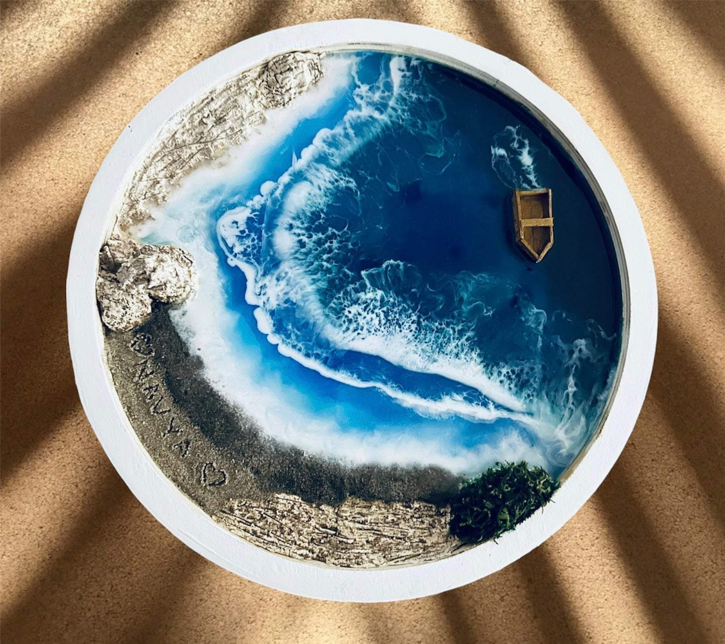 12-inch round ocean art for home decor with resin waves, sandy shore, small boat, and white frame